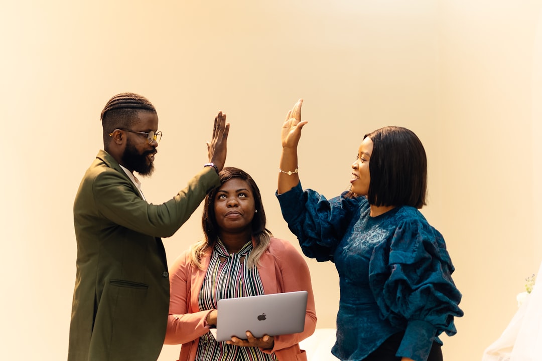 A team of three people, a man and two women standing together. Find more afro-centric images at www.ninthgrid.com